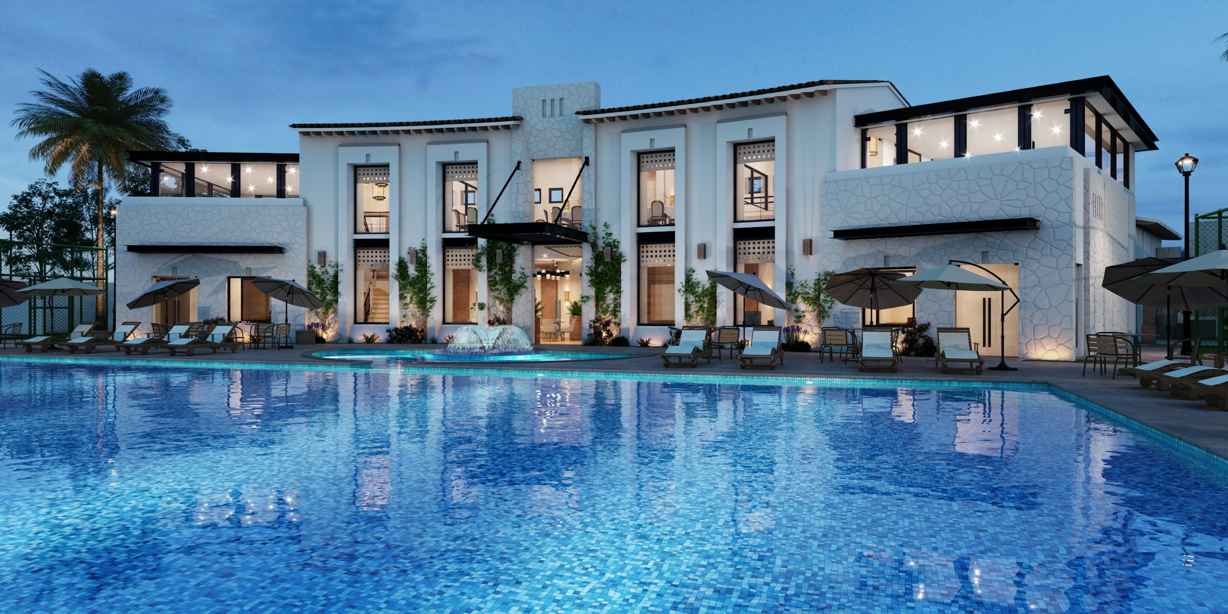Lit villa and pool at dusk